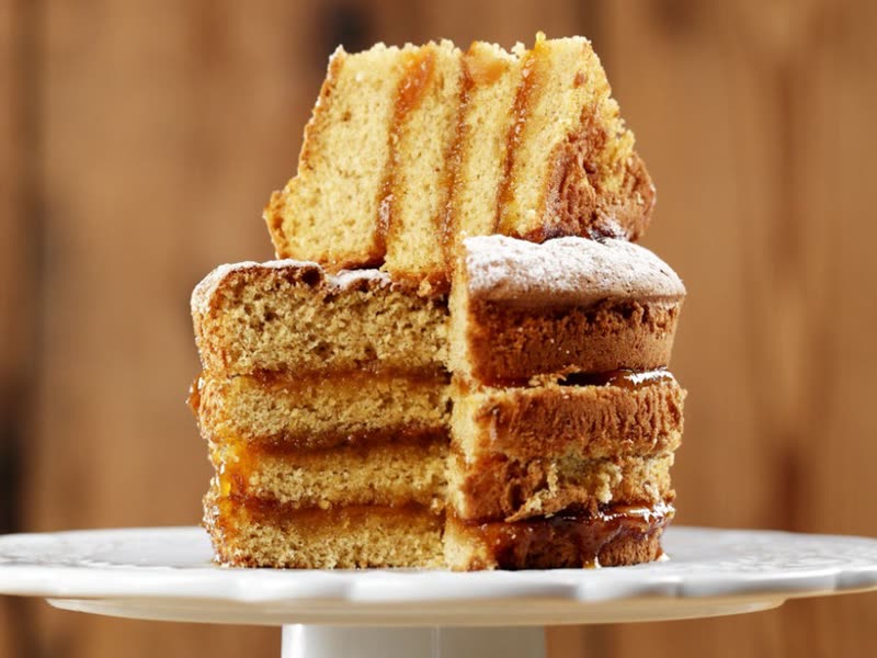 Layered spice cake on a white cake stand