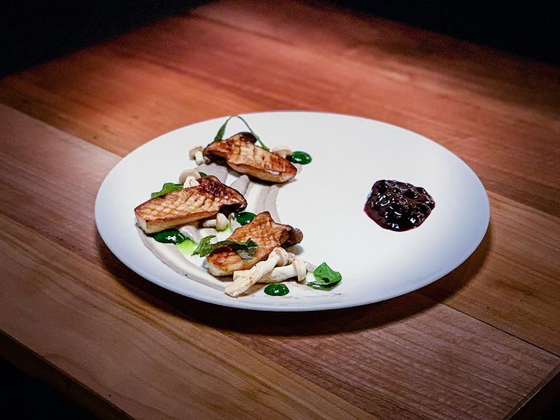 King oyster mushrooms on mushroom and spinach cream with cherry chutney to the side