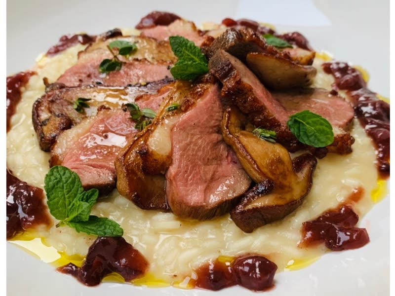 Risotto with slices of pink duck breast, porcini and plum chutney